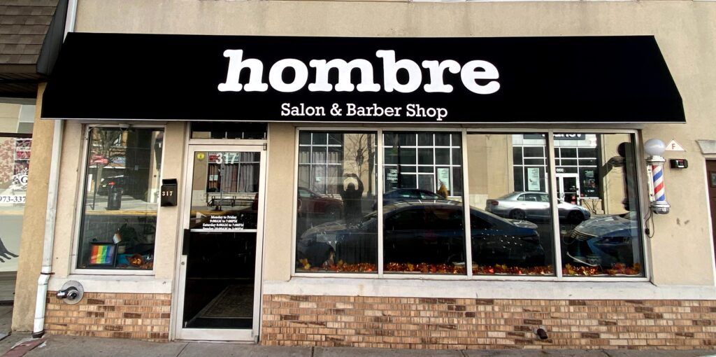 Storefront awning with custom business lettering and graphics