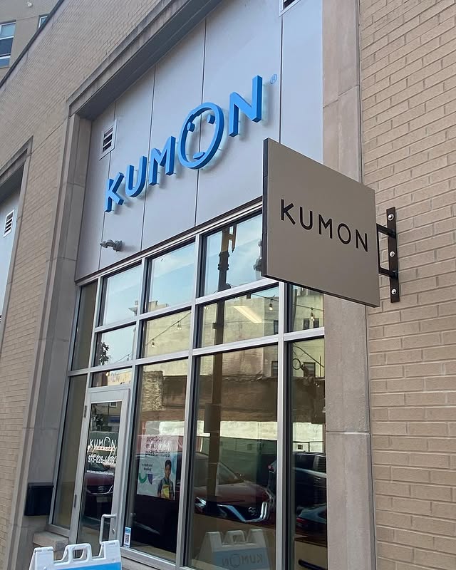 AVI Design team installing dimensional letters in a corporate lobby