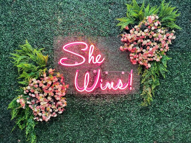 Traditional hand-bent glass neon sign with warm red and blue glow