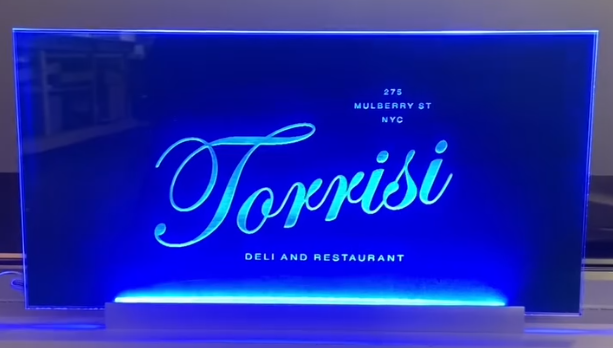 Custom LED open sign glowing in a business window display