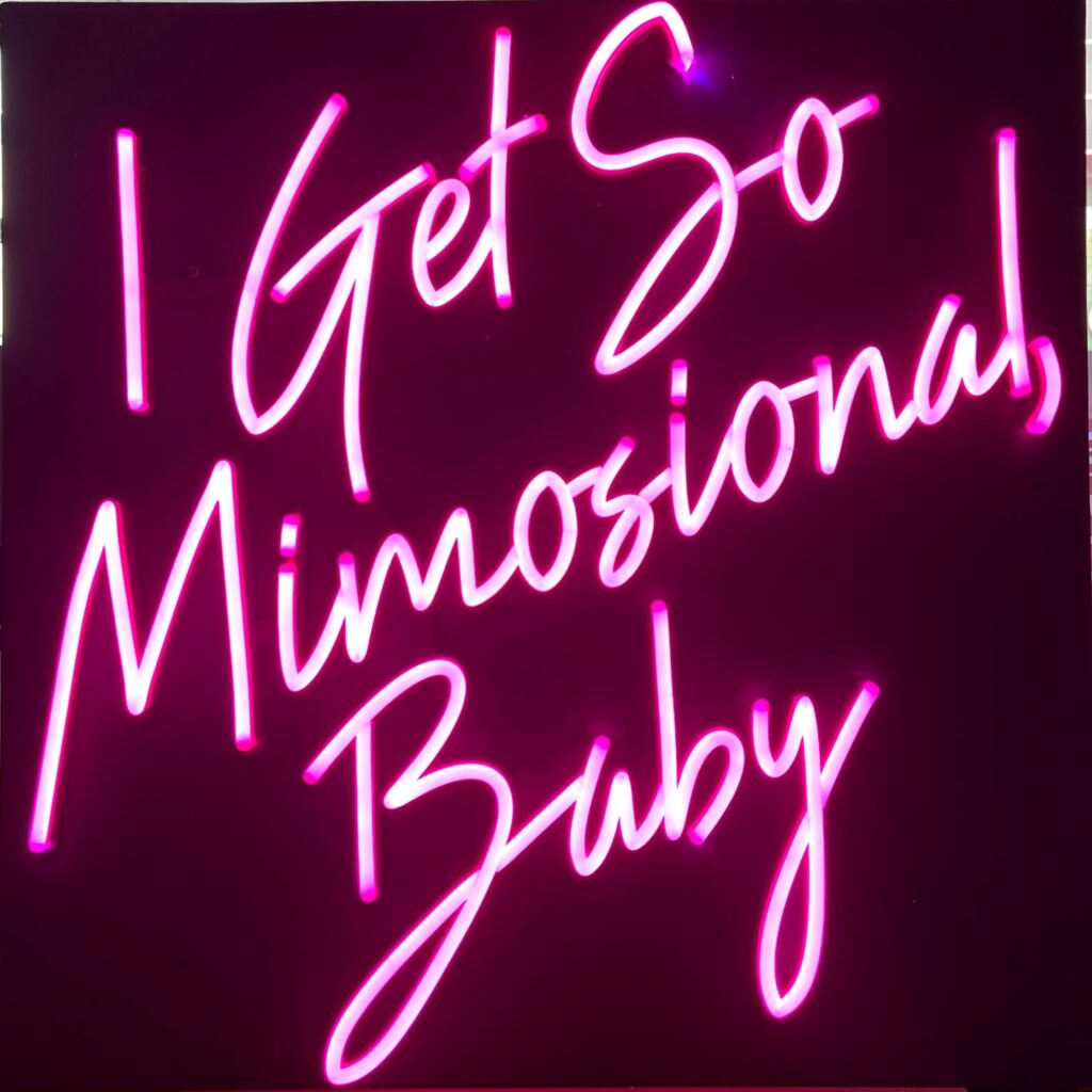 Custom LED neon flex sign with vibrant colors mounted on a dark wall