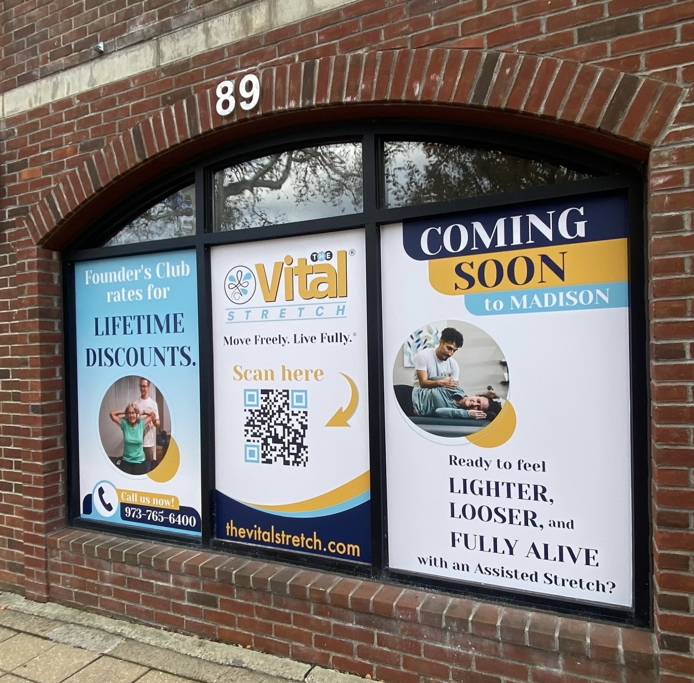 Close-up of vinyl window graphics being applied to a storefront window